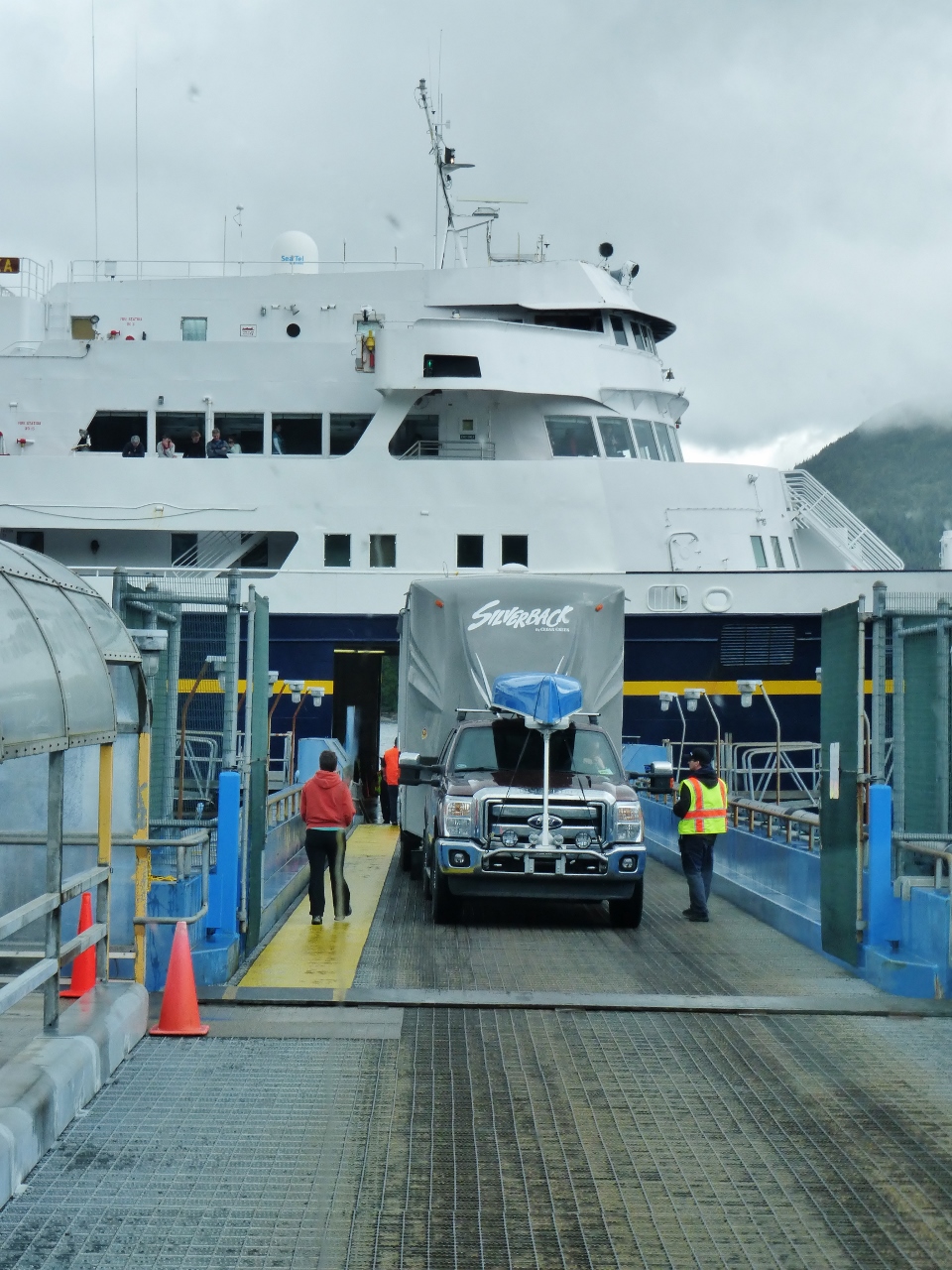 Getting on the ferry can be nerve-wracking because the causeway is narrow and they pack you in inches from each other and from the walls.  This is a friend of ours we met in Ketchikan who is backing his fifth wheel  onto the deck, and doing it expertly.
