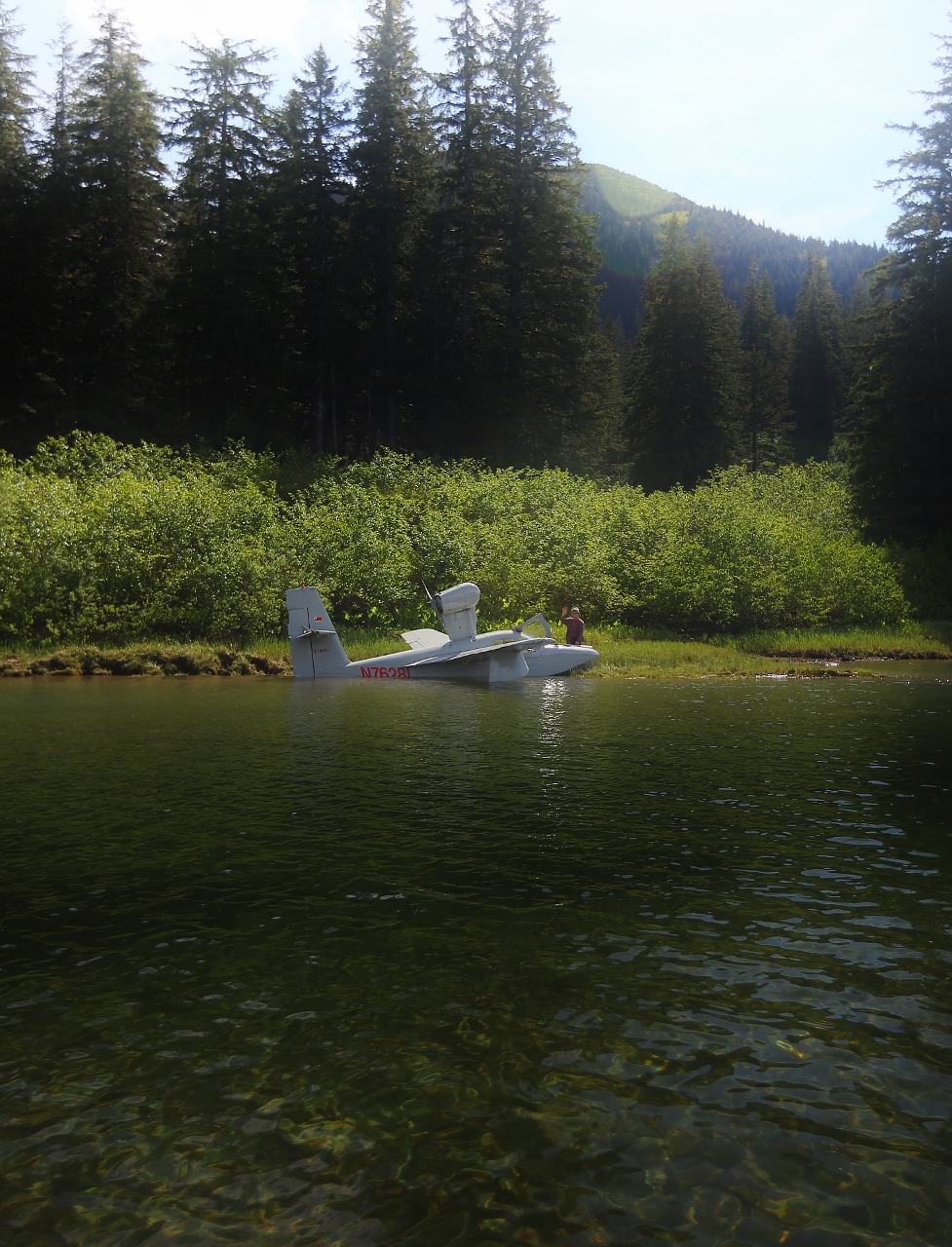 A small float plane.  The fellow set down in the wilderness to have a box lunch, then he'll be on his way, using the river as a runway.